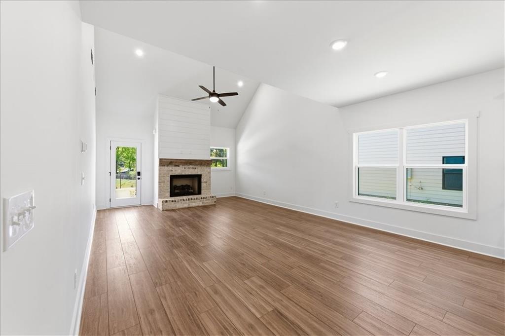141 Old Alabama Road Southeast Emerson, GA 30137 - Photo 23 of 47 an empty room with wooden floor fireplace and windows