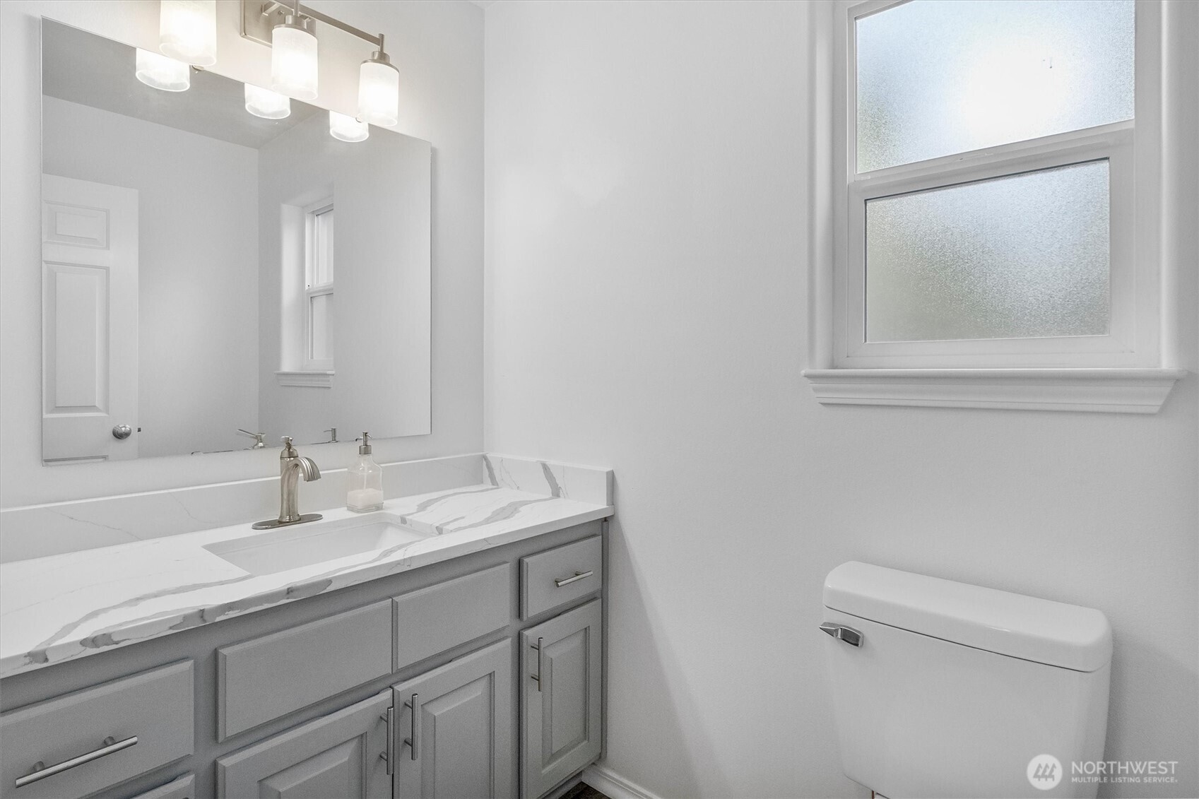 705 Finley Lane, Unit N2 La Conner, WA 98257 - Photo 15 of 38 a bathroom with a sink a toilet and a mirror