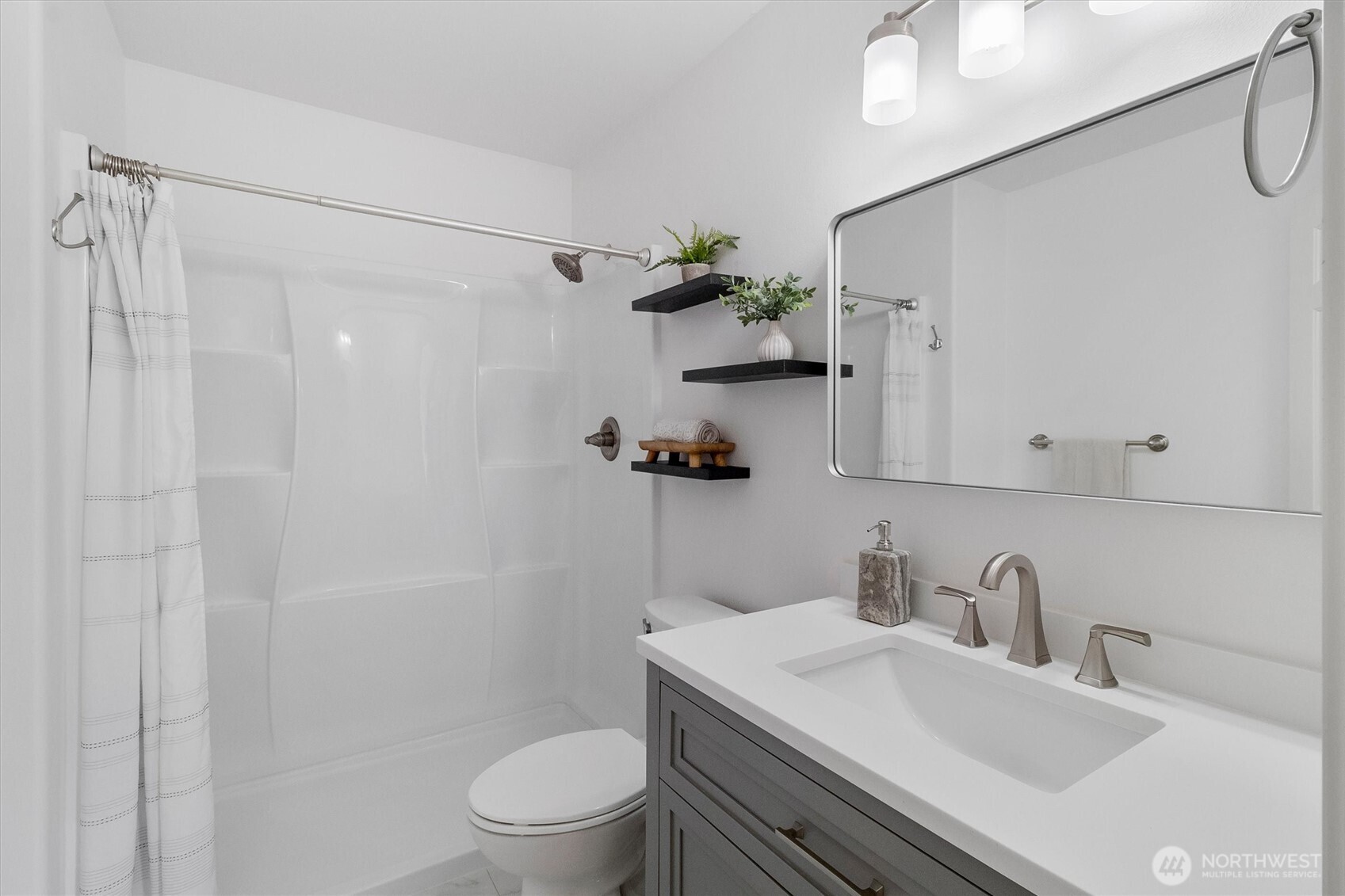 705 Finley Lane, Unit N2 La Conner, WA 98257 - Photo 22 of 38 a bathroom with a sink toilet a mirror and shower