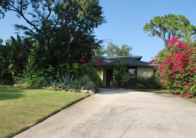 a front view of a house with a yard and a garage