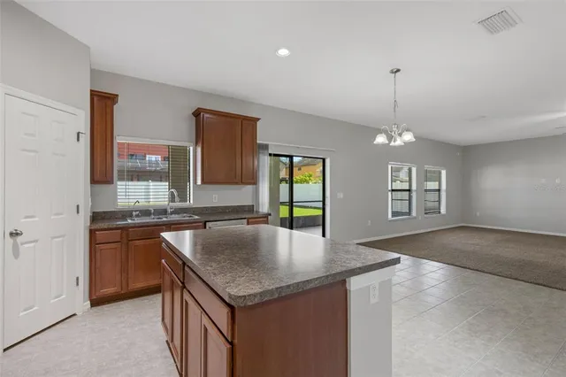 a kitchen with kitchen island a sink appliances and a counter space