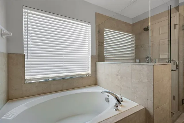 a bathroom with a bathtub and a window