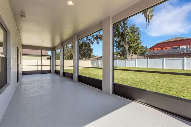 a view of an empty room with a floor to ceiling window and an outdoor view