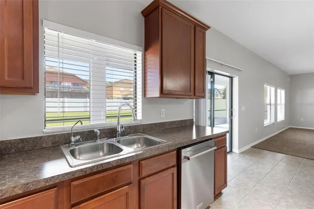 a kitchen with granite countertop a sink and a window