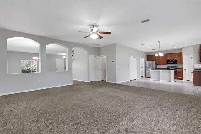 a view of a kitchen with a sink and a chandelier fan