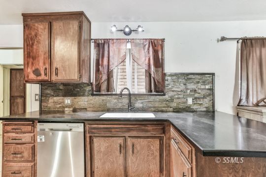626 West Kevin Court Ridgecrest, CA 93555 - Photo 20 of 34 a kitchen with stainless steel appliances granite countertop a sink a stove and a microwave