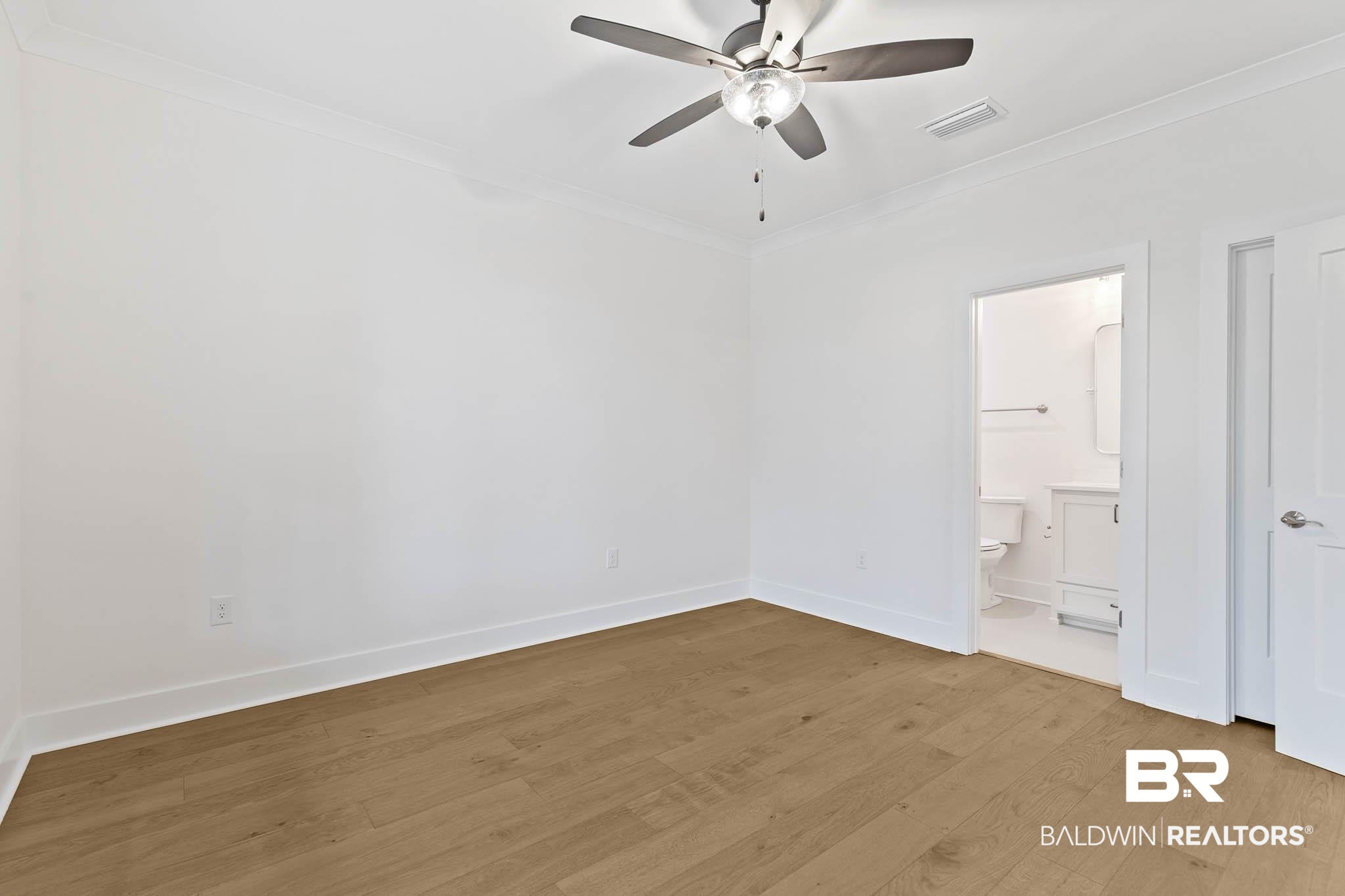 6656 Garrison Drive Daphne, AL 36527 - Photo 10 of 57 Unfurnished bedroom with ornamental molding, wood finished floors, a ceiling fan, and ensuite bathroom