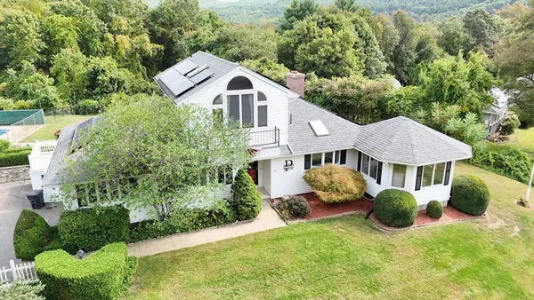 a aerial view of a house with a yard and plants