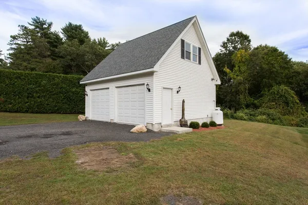 a view of a house with backyard and trees