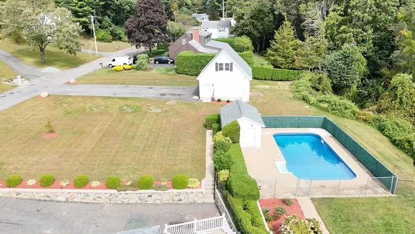 an aerial view of a house with swimming pool and outdoor space