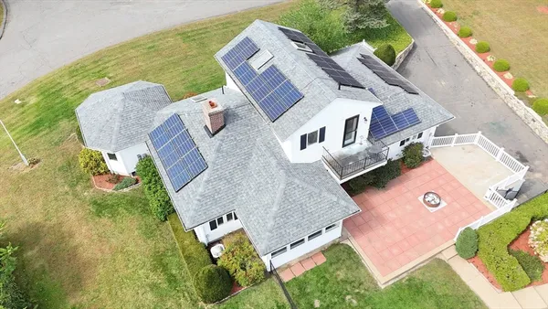 an aerial view of a house with outdoor space