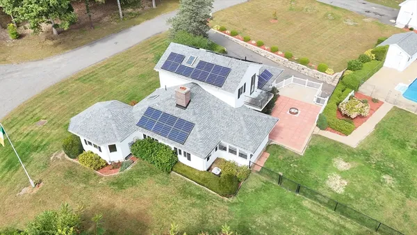 an aerial view of a house with a swimming pool and outdoor space
