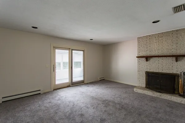 an empty room with a fireplace