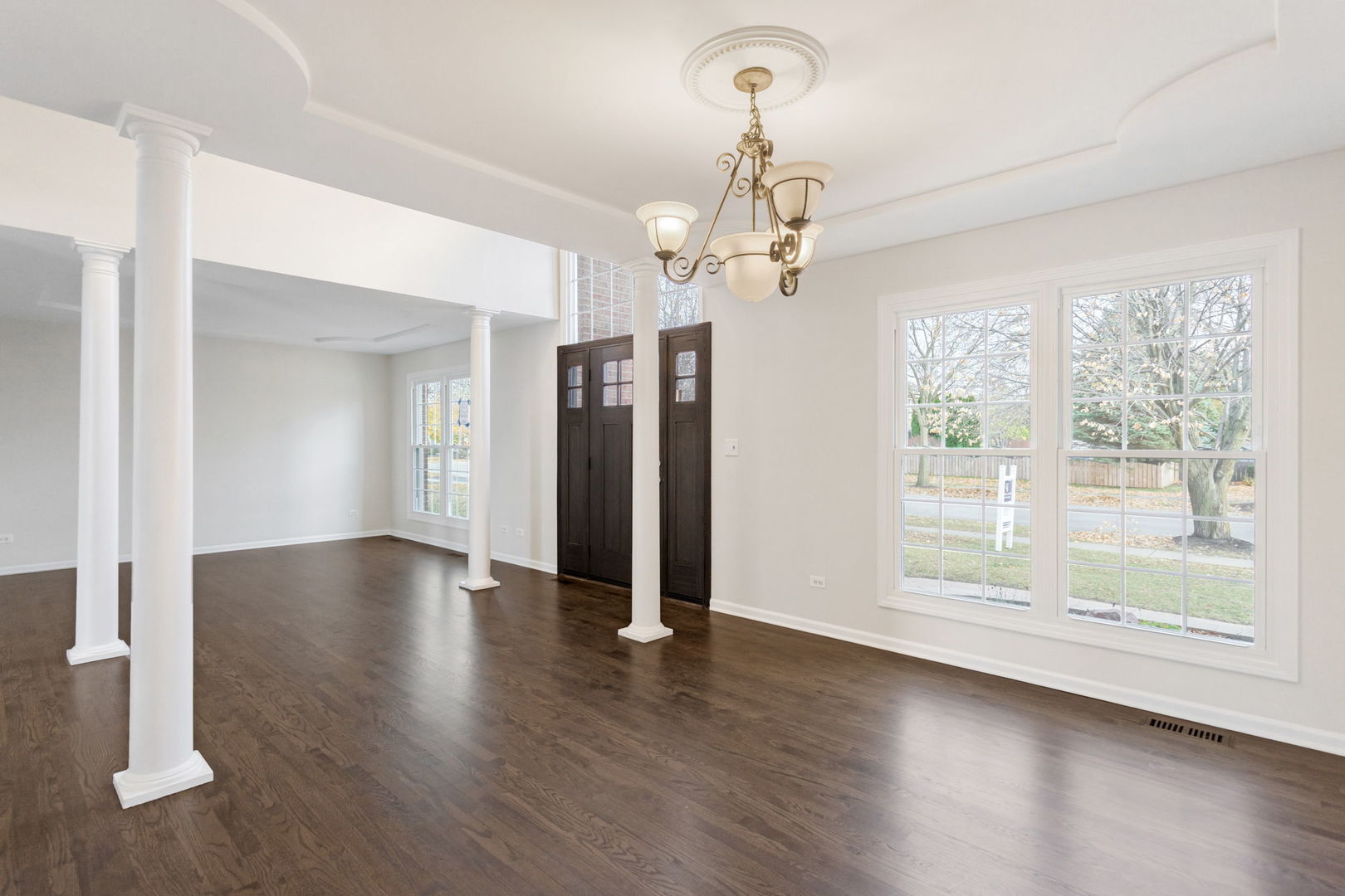 537 Arbor Lane Oswego, IL 60543 - Photo 10 of 33 a view of a livingroom with wooden floor and a ceiling fan