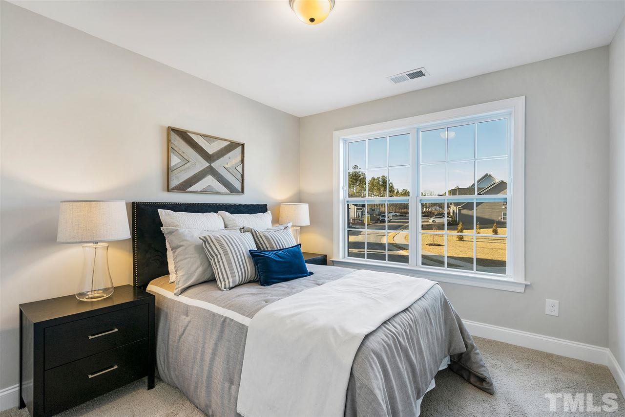 112 Edmer Lane Garner, NC 27529 - Photo 13 of 24 a bedroom with a bed and a night stand