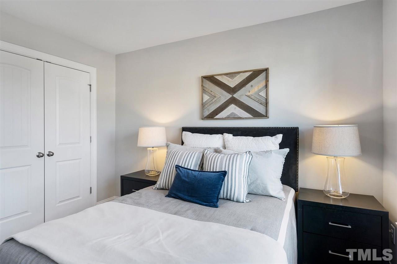 112 Edmer Lane Garner, NC 27529 - Photo 15 of 24 a bedroom with a bed and a night stand