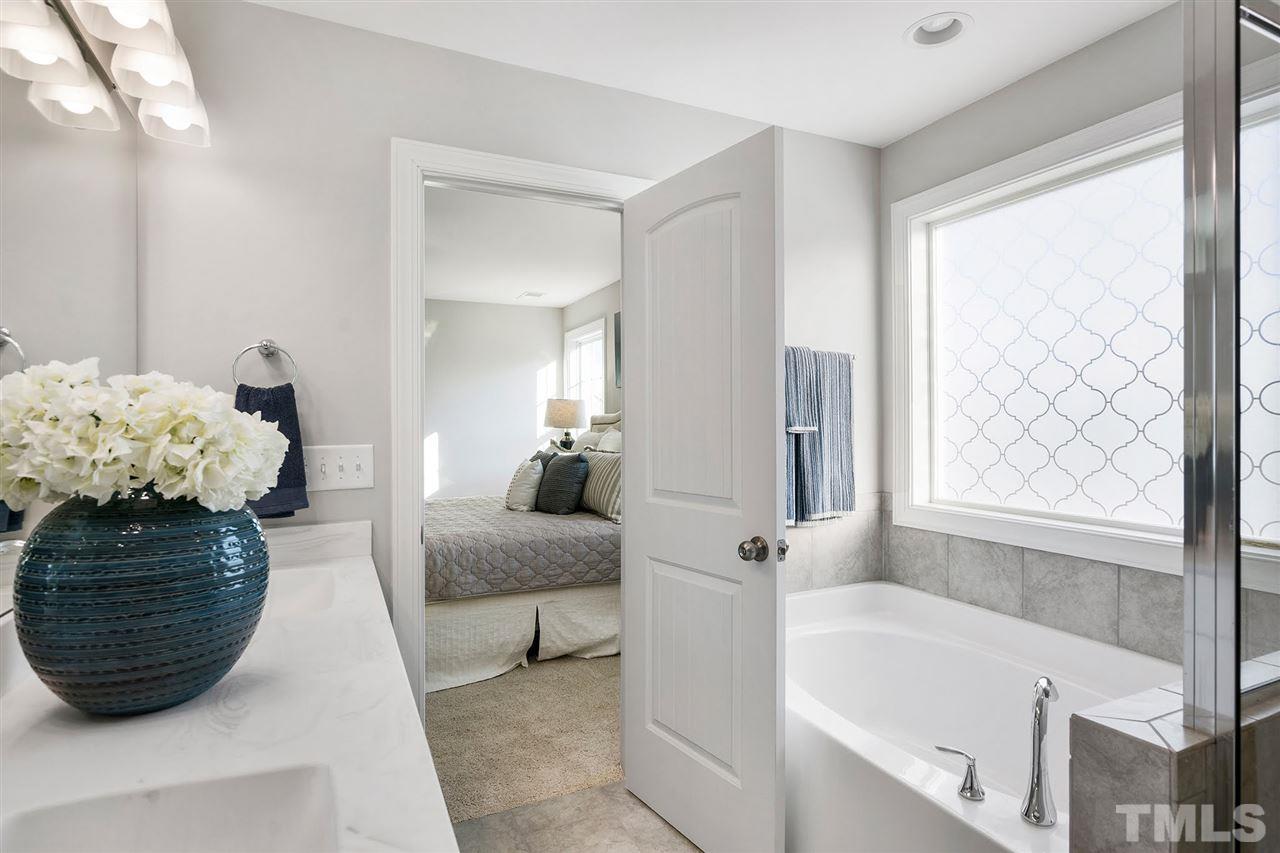 112 Edmer Lane Garner, NC 27529 - Photo 18 of 24 a bathroom with a bathtub and a shower