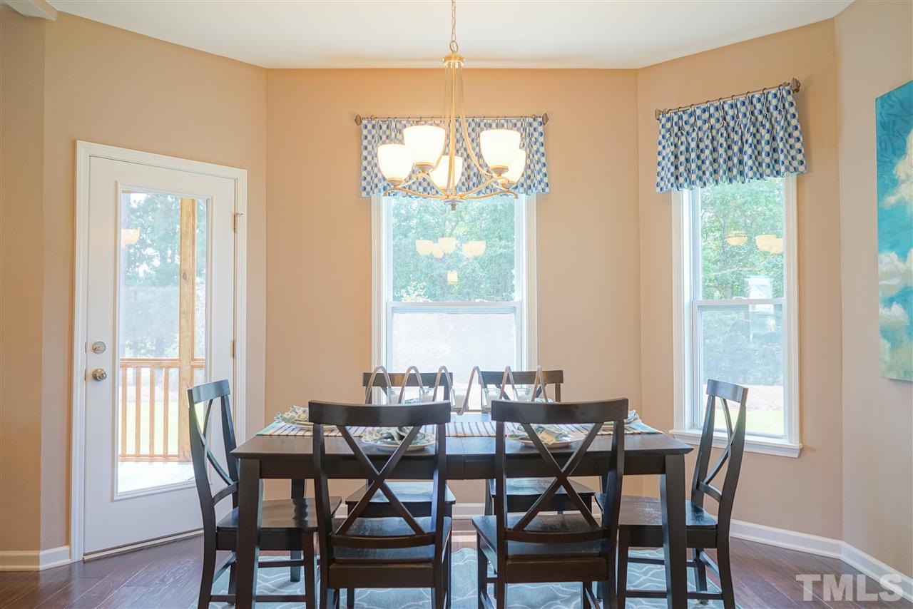 112 Edmer Lane Garner, NC 27529 - Photo 19 of 24 a view of a dining room with furniture window and wooden floor