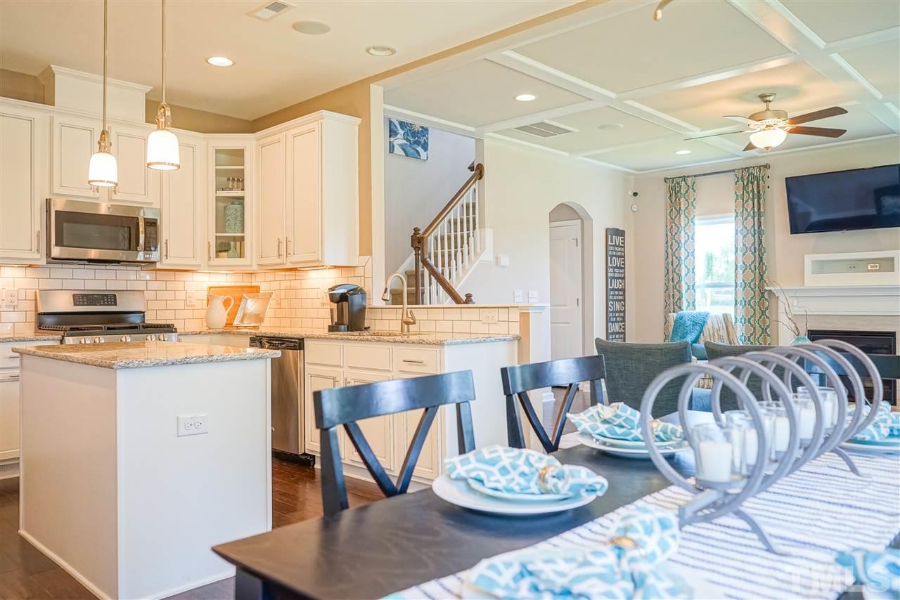 112 Edmer Lane Garner, NC 27529 - Photo 21 of 24 a living room with furniture and a dining table with kitchen view