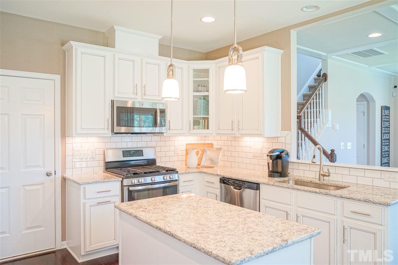 112 Edmer Lane Garner, NC 27529 - Photo 22 of 24 a kitchen with a sink stove top oven and refrigerator