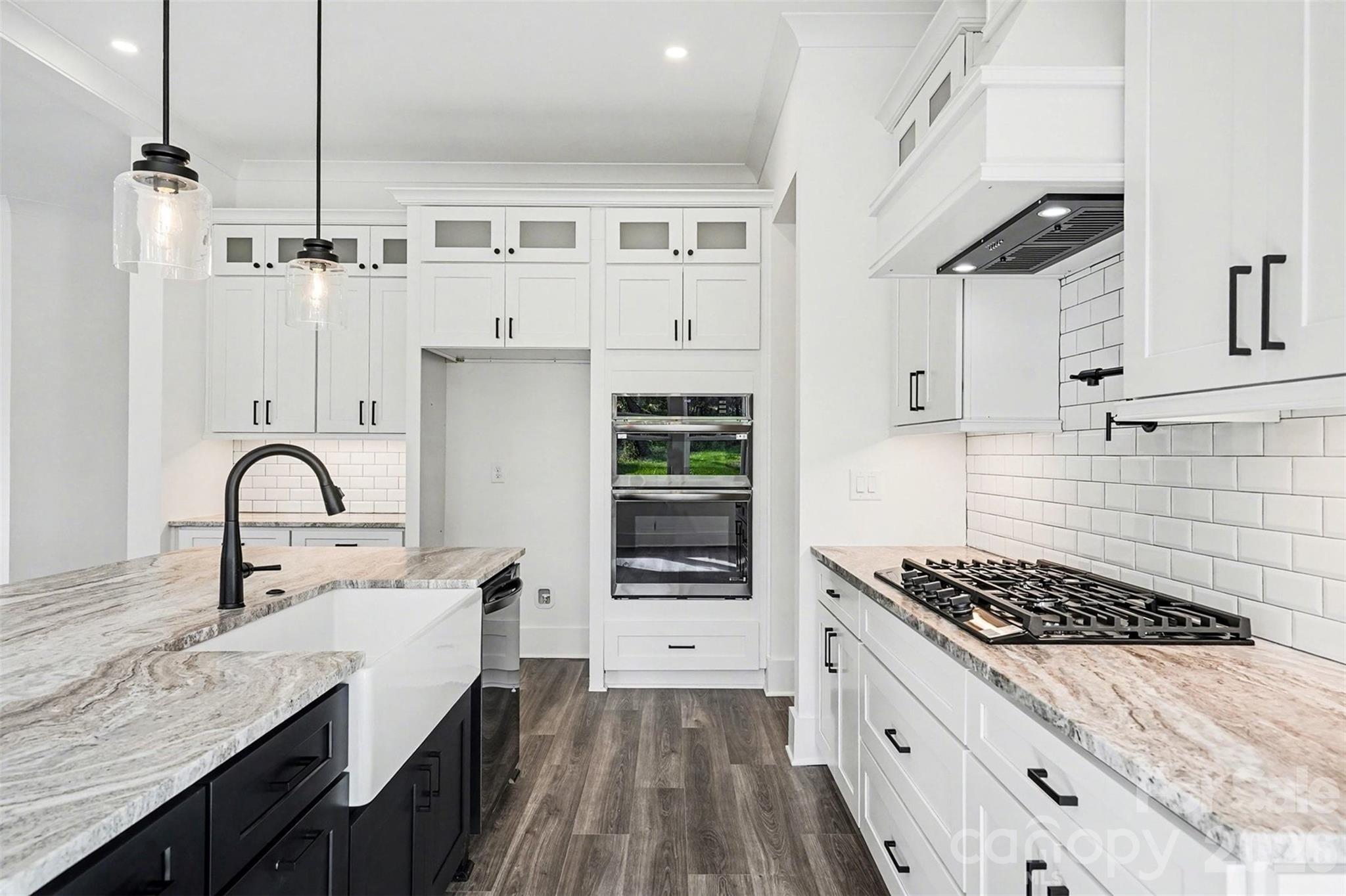 149 Shady Cove Road Troutman, NC 28166 - Photo 14 of 48 a kitchen with stainless steel appliances a sink stove and cabinets