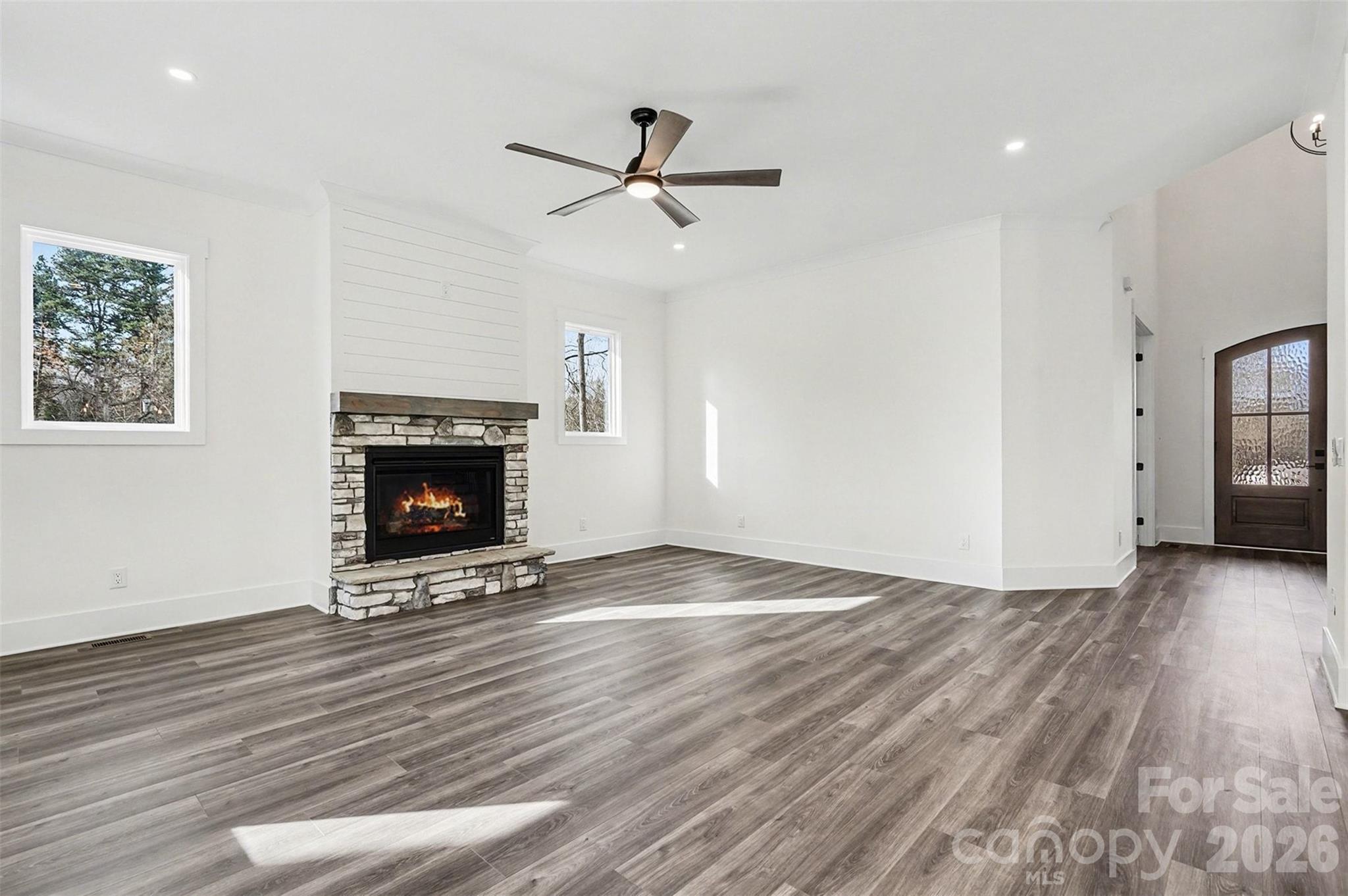 149 Shady Cove Road Troutman, NC 28166 - Photo 18 of 48 a view of empty room with wooden floor and fireplace