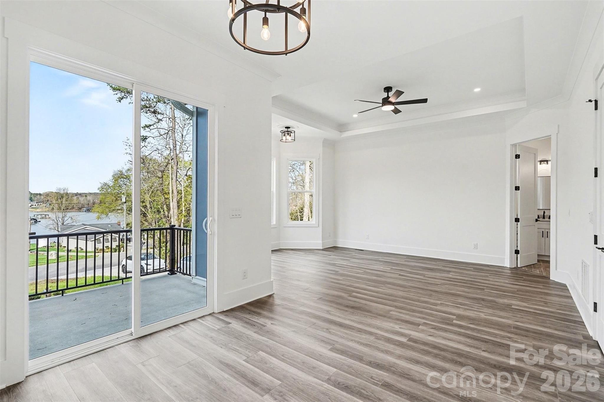 149 Shady Cove Road Troutman, NC 28166 - Photo 21 of 48 a view of a room with wooden floor and windows