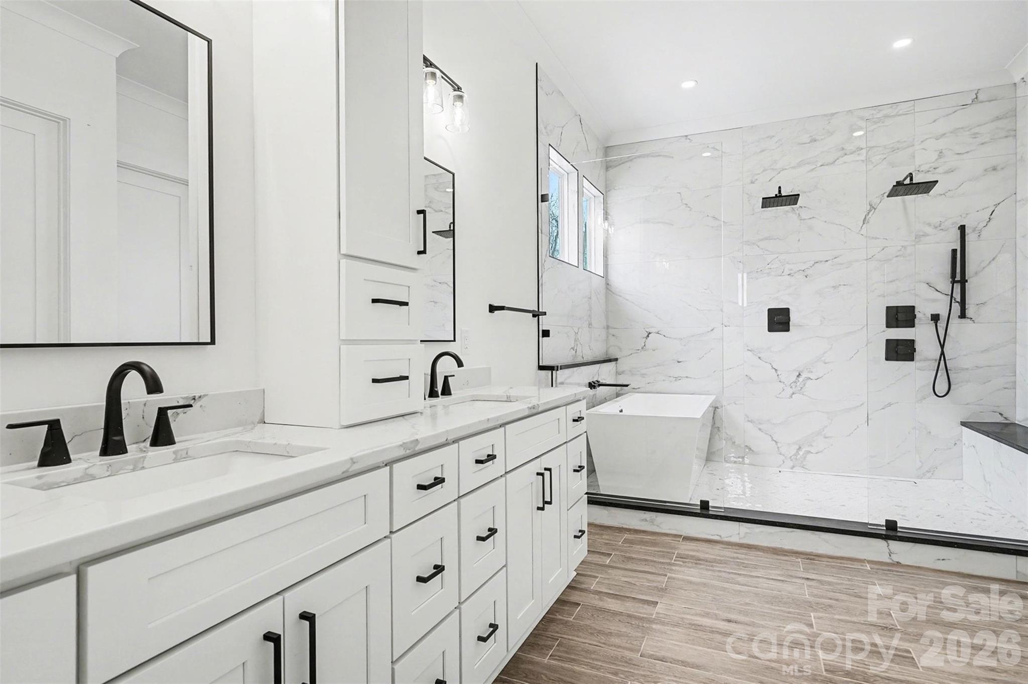 149 Shady Cove Road Troutman, NC 28166 - Photo 24 of 48 a bathroom with double vanity sink a mirror and a shower