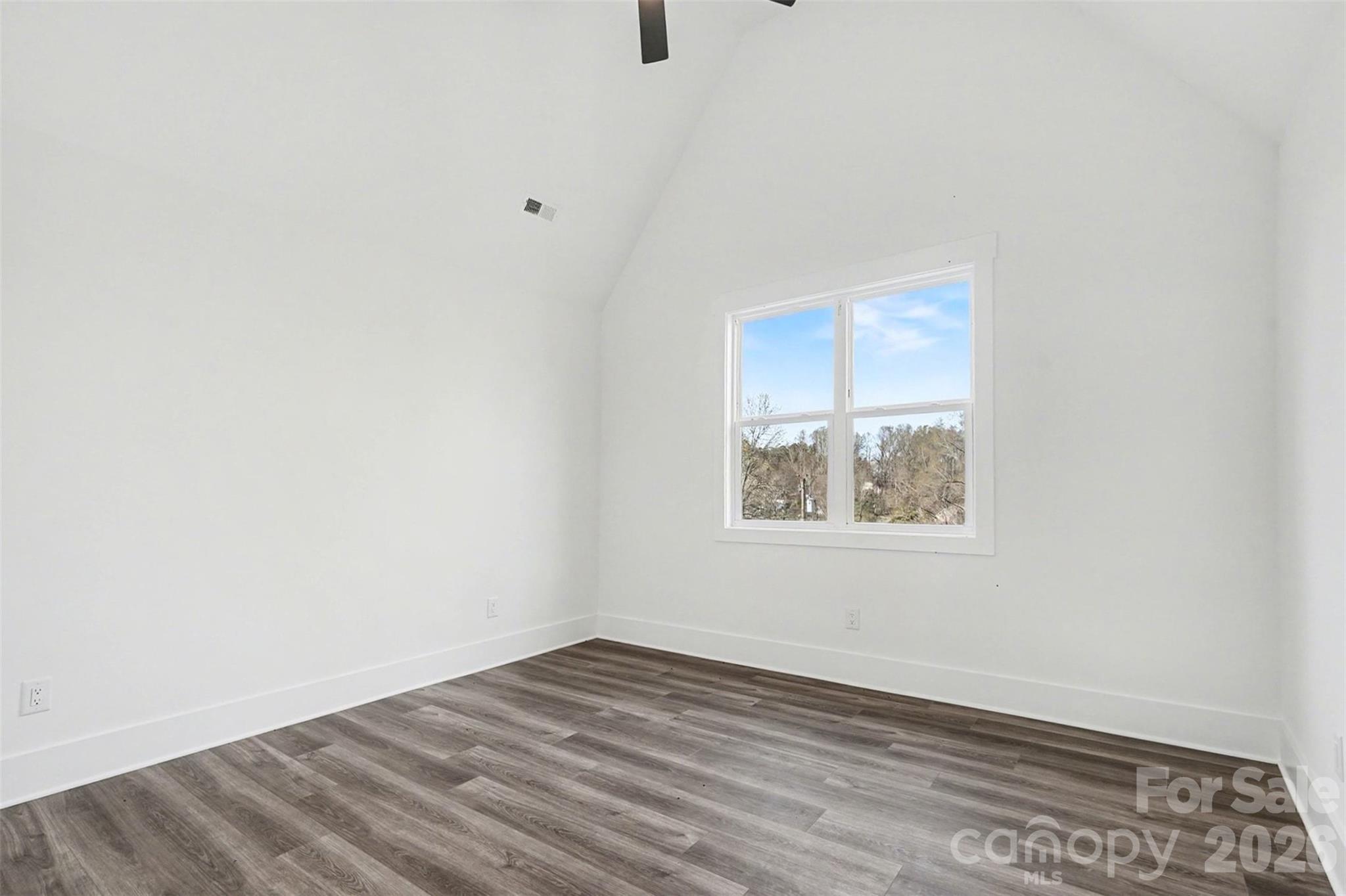 149 Shady Cove Road Troutman, NC 28166 - Photo 27 of 48 an empty room with wooden floor and windows