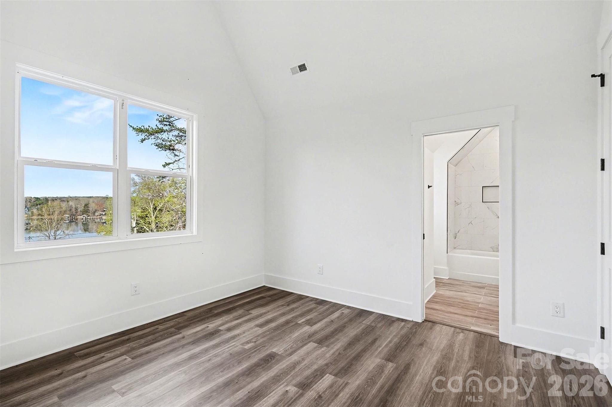 149 Shady Cove Road Troutman, NC 28166 - Photo 28 of 48 a view of an empty room with wooden floor and a window
