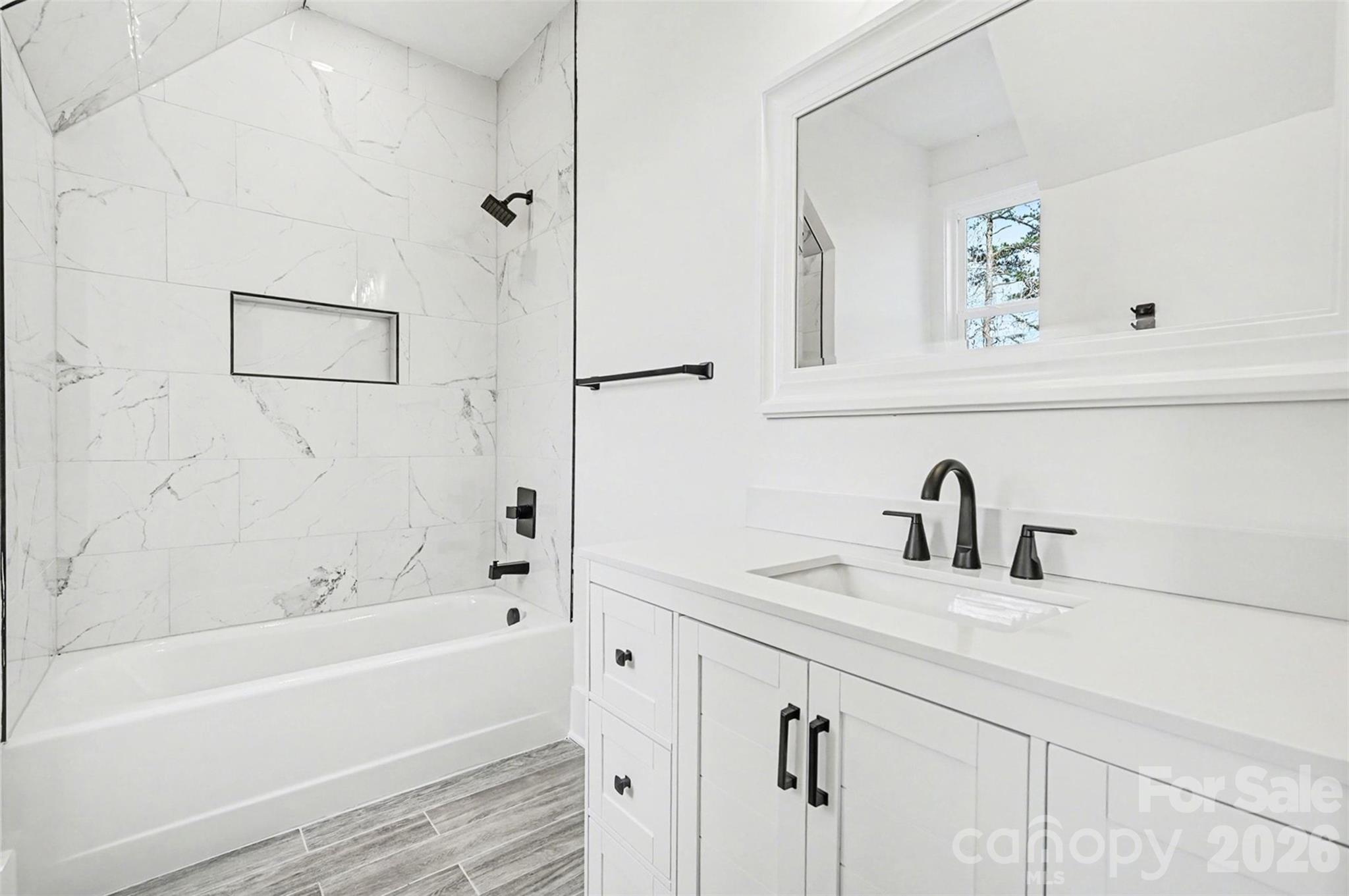 149 Shady Cove Road Troutman, NC 28166 - Photo 29 of 48 a bathroom with a sink and a bathtub