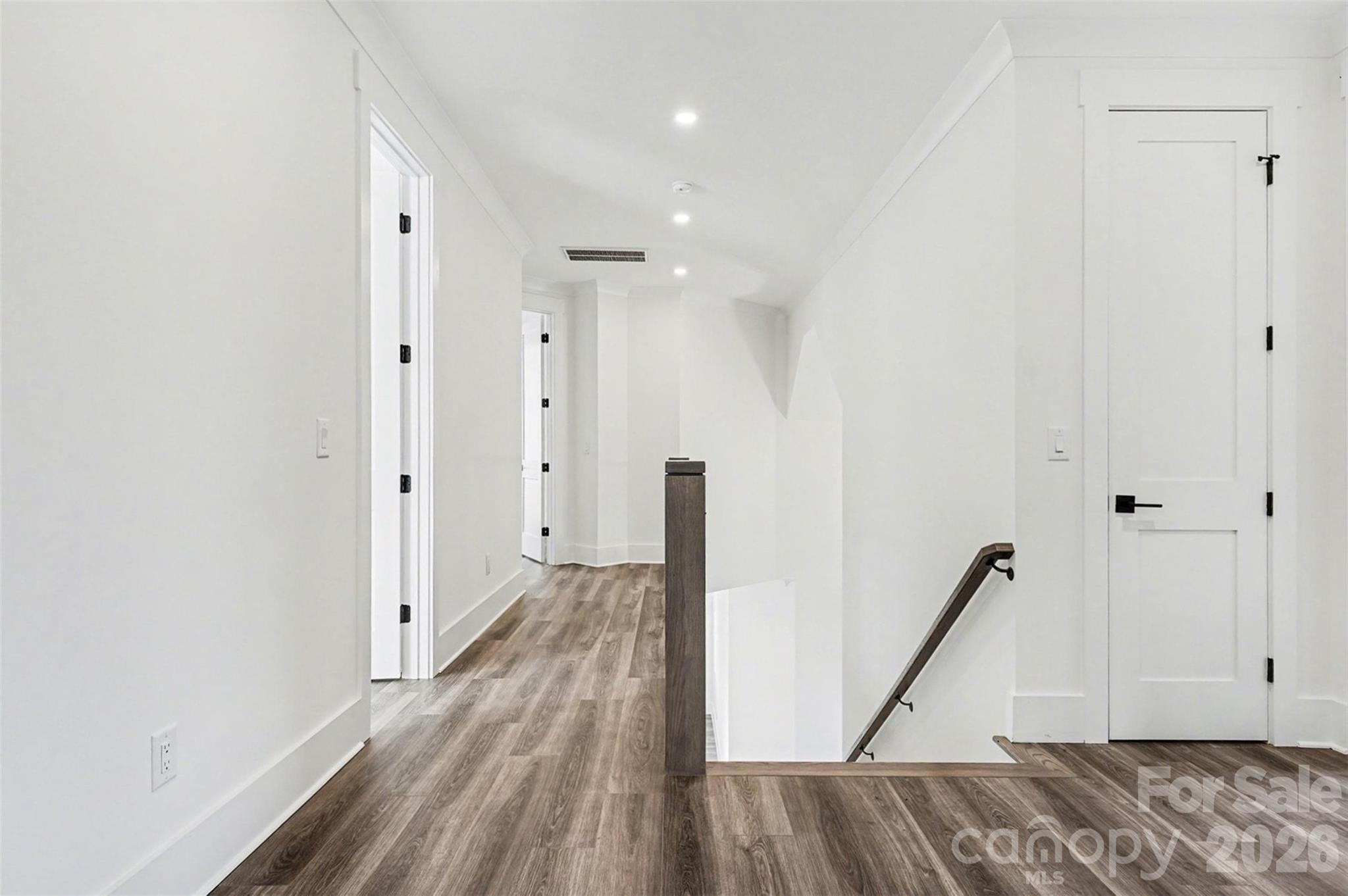 149 Shady Cove Road Troutman, NC 28166 - Photo 32 of 48 a view of a room with wooden floor and a ceiling fan