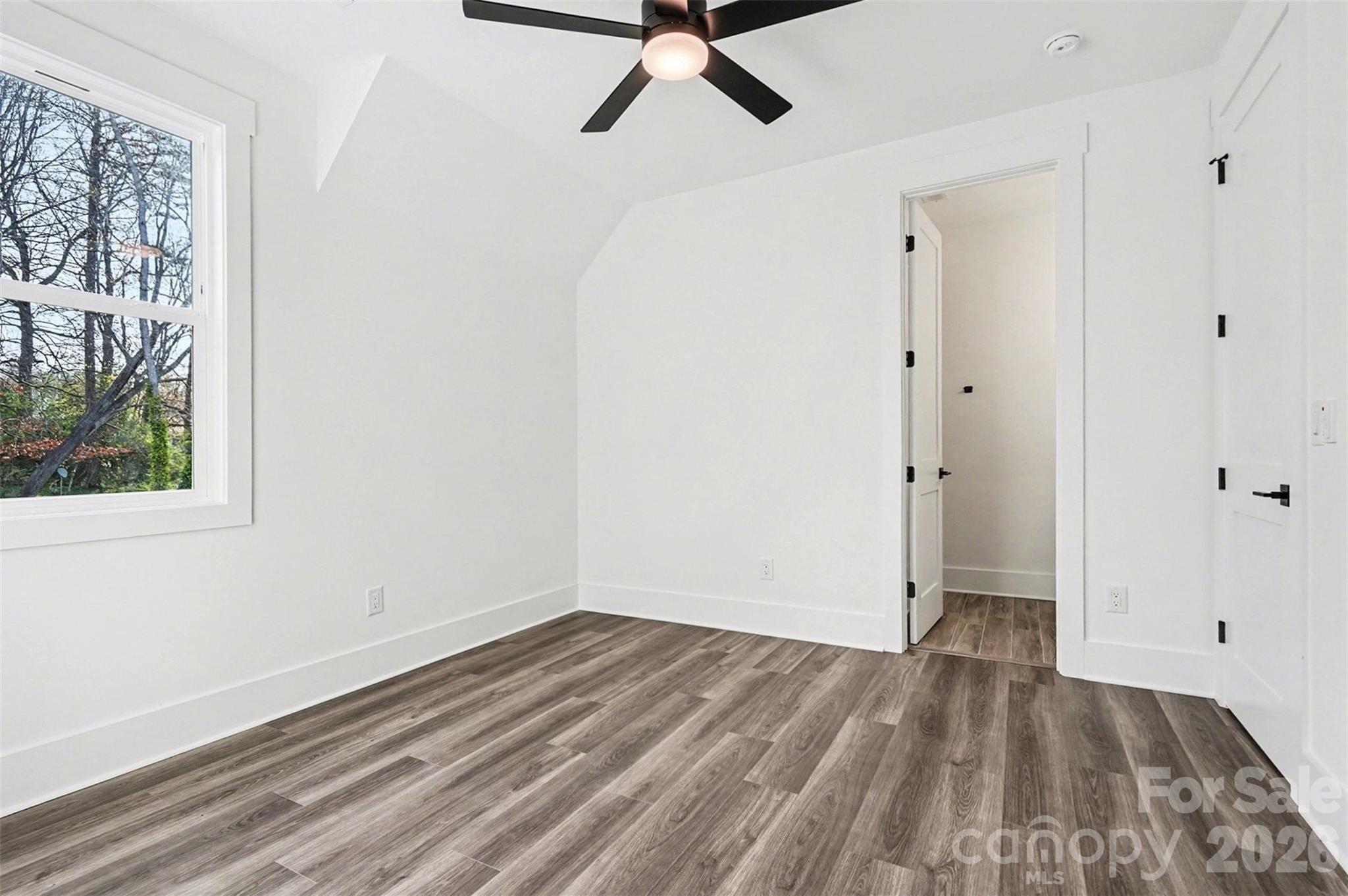 149 Shady Cove Road Troutman, NC 28166 - Photo 35 of 48 a view of a room with wooden floor and a ceiling fan