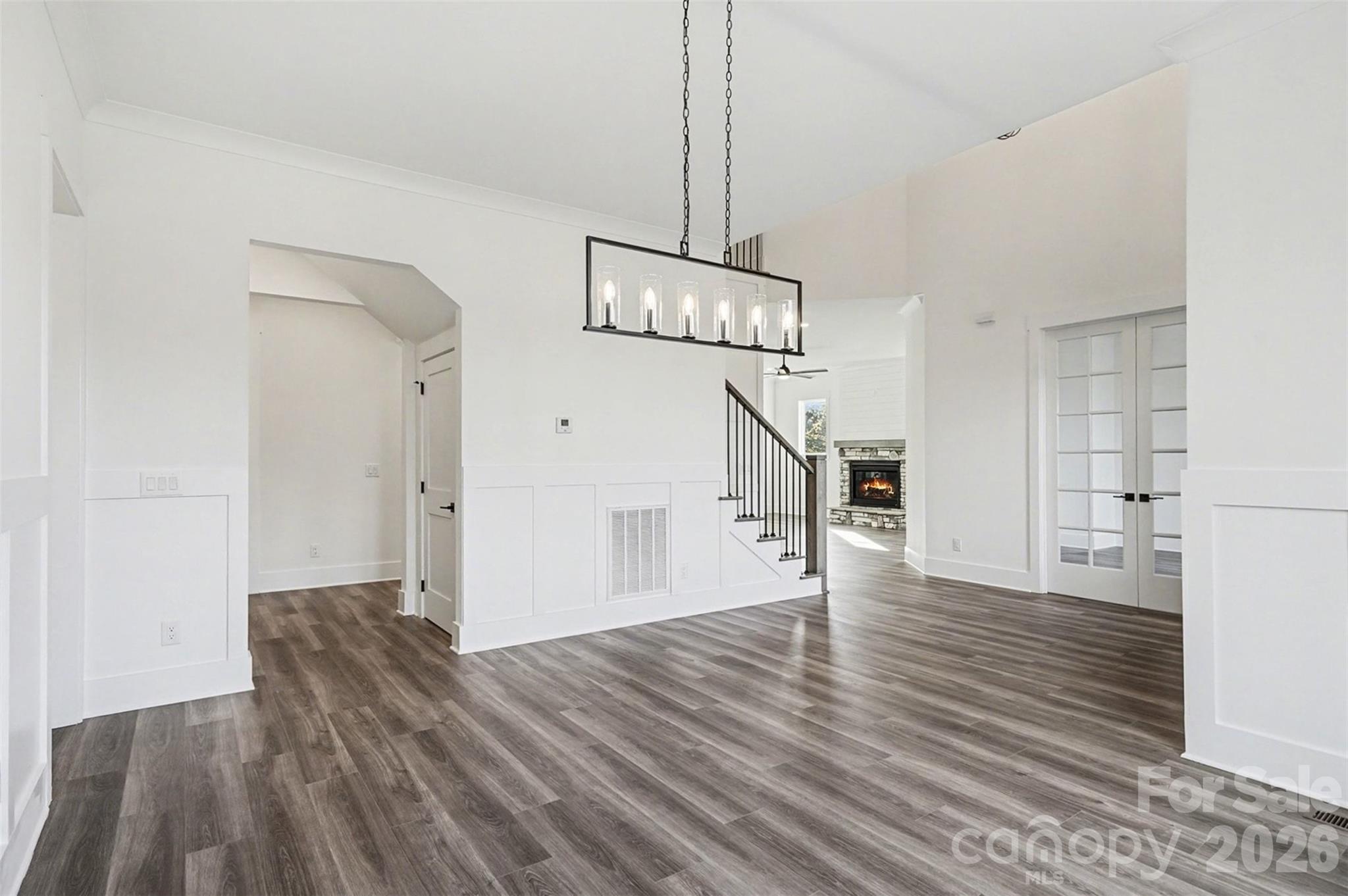 149 Shady Cove Road Troutman, NC 28166 - Photo 10 of 48 a view of a room with wooden floor staircase and a kitchen space