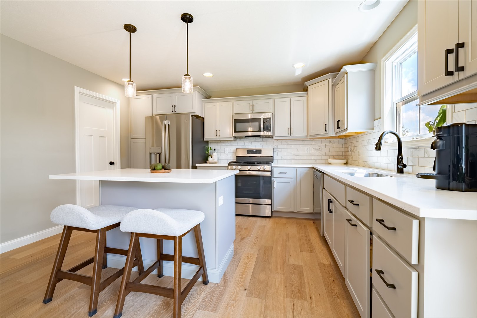 2512 Savanna Road Bloomington, IL 61705 - Photo 11 of 31 a kitchen with stainless steel appliances kitchen island granite countertop a sink a stove a refrigerator and island with wooden floor