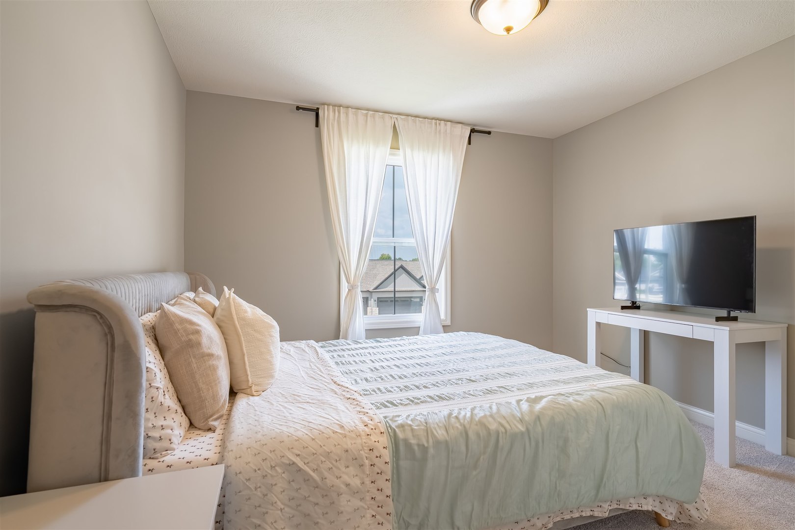 2512 Savanna Road Bloomington, IL 61705 - Photo 18 of 31 a bedroom with a bed and a flat screen tv