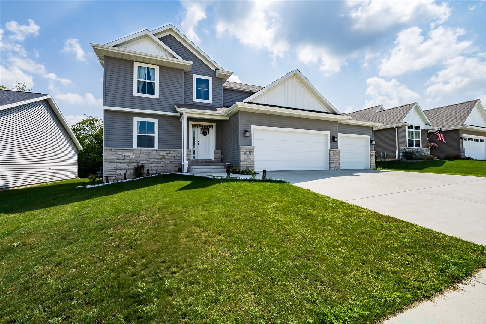 2512 Savanna Road Bloomington, IL 61705 - Photo 2 of 31 a front view of a house with a yard and trees