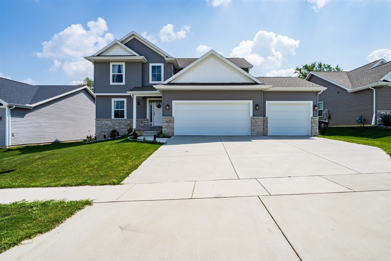 2512 Savanna Road Bloomington, IL 61705 - Photo 30 of 31 a front view of a house with a yard and garage