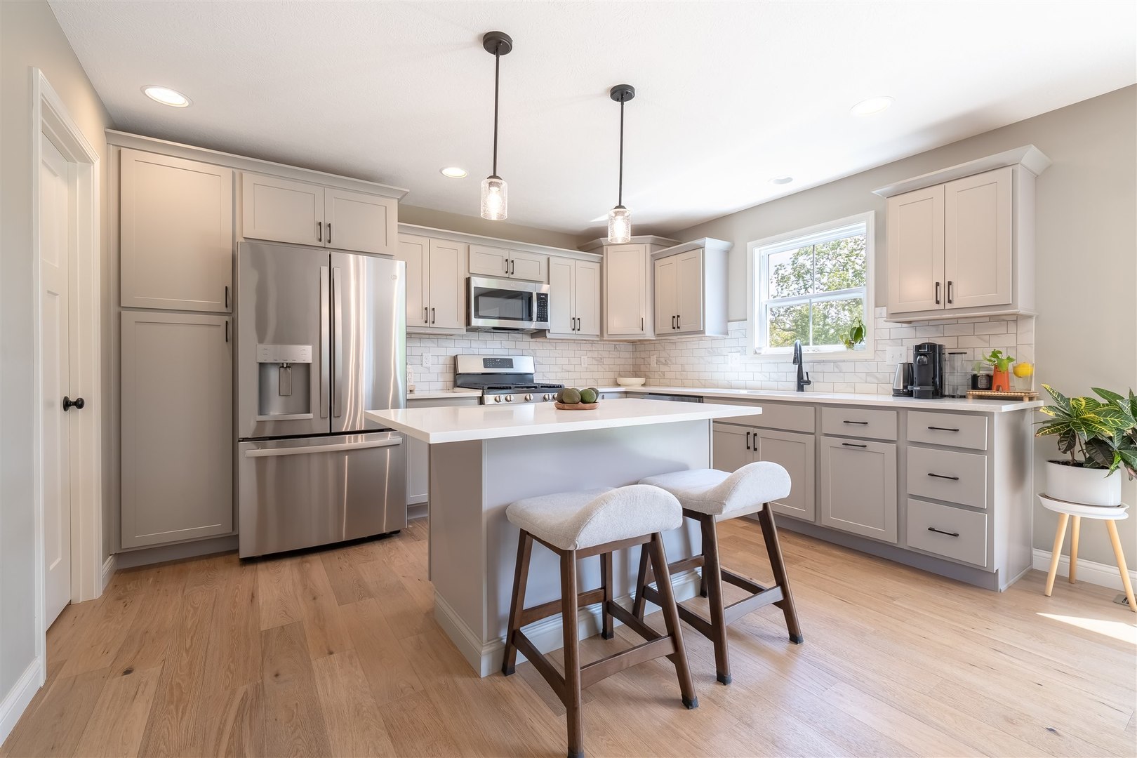 2512 Savanna Road Bloomington, IL 61705 - Photo 10 of 31 a kitchen with stainless steel appliances granite countertop a refrigerator a stove a sink dishwasher a dining table and chairs with wooden floor