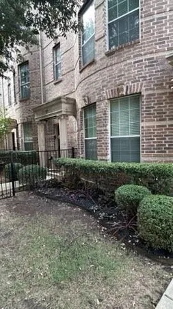 a view of a brick building with many windows