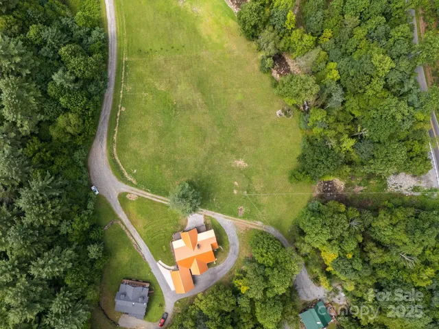 an aerial view of a residential houses with outdoor space