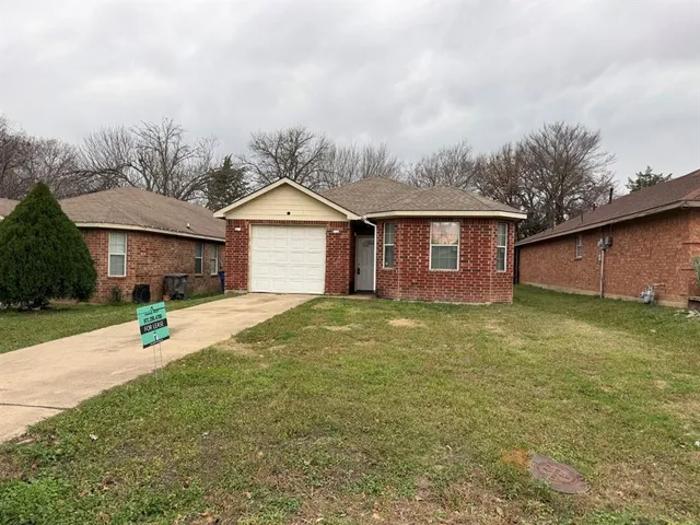a view of a yard in front of a house with a garden