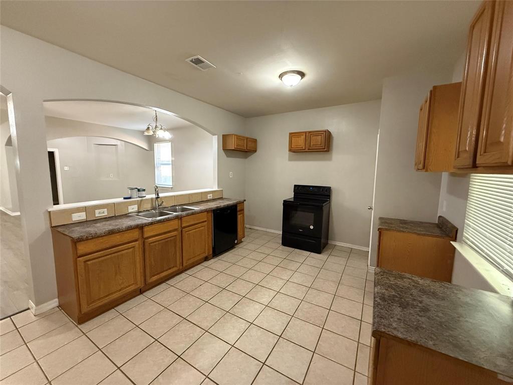 1823 Smoke Tree Lane Dallas, TX 75253 - Photo 11 of 13 a kitchen with stainless steel appliances granite countertop a sink and a refrigerator