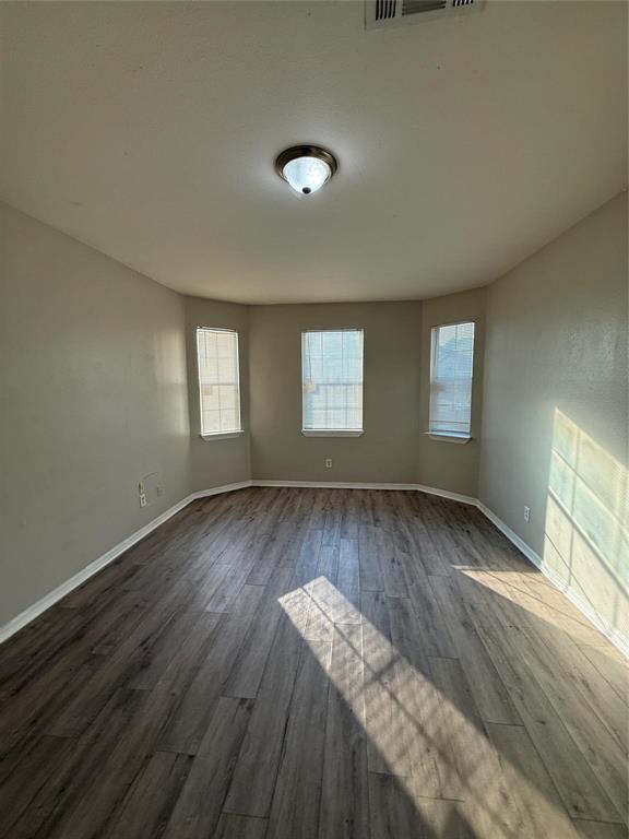 1823 Smoke Tree Lane Dallas, TX 75253 - Photo 3 of 13 an empty room with wooden floor and windows