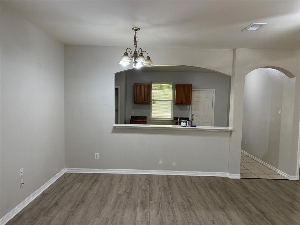 1823 Smoke Tree Lane Dallas, TX 75253 - Photo 7 of 13 wooden floor in an empty room with a mirror