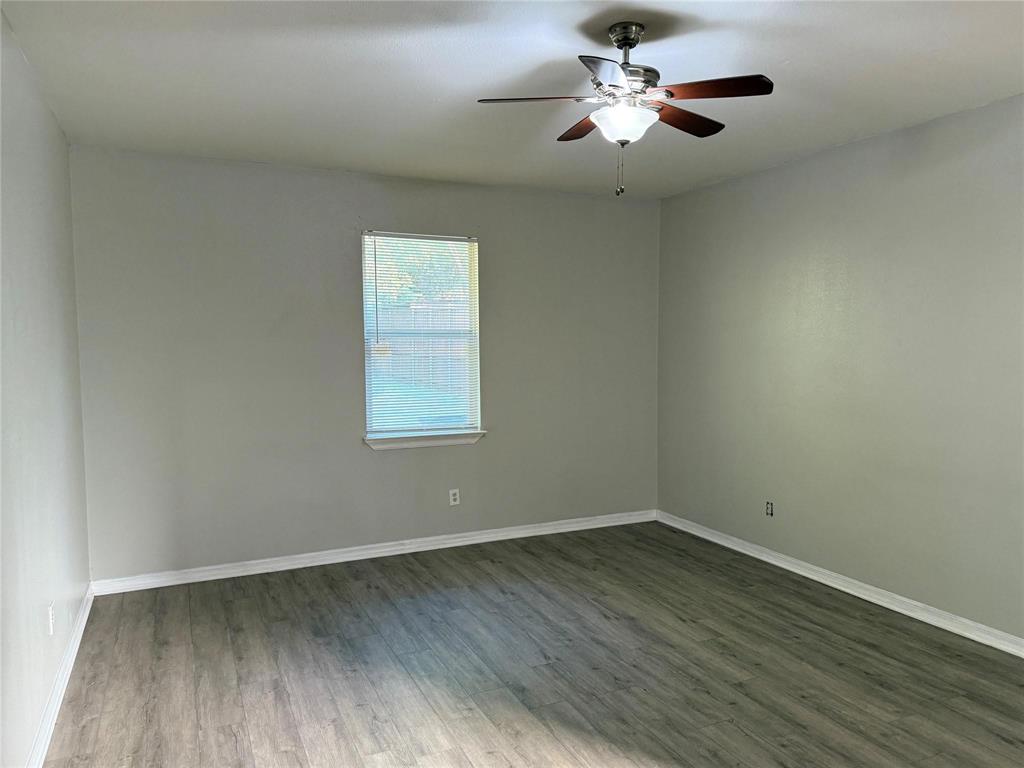 1823 Smoke Tree Lane Dallas, TX 75253 - Photo 9 of 13 a view of a room with wooden floor and a ceiling fan