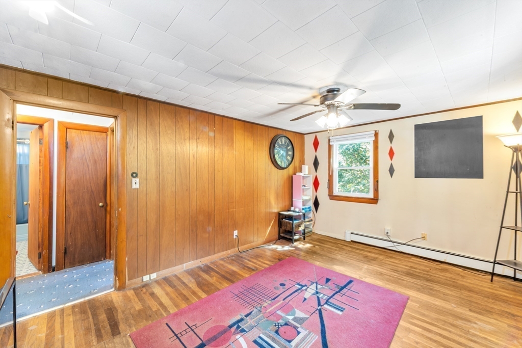 324 Central Avenue Dedham, MA 02026 - Photo 11 of 27 a bedroom with a bed and a chandelier