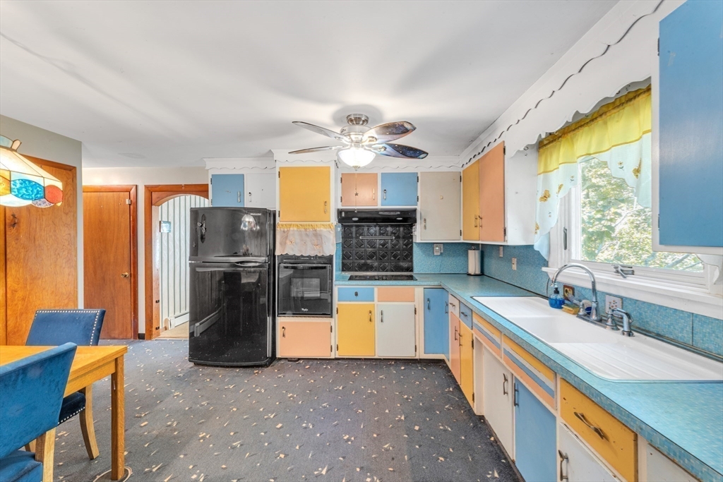 324 Central Avenue Dedham, MA 02026 - Photo 12 of 27 a kitchen with refrigerator and cabinets