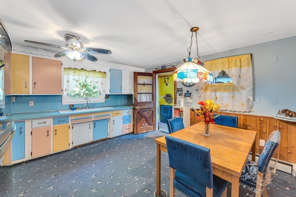 324 Central Avenue Dedham, MA 02026 - Photo 13 of 27 a kitchen with kitchen island granite countertop a sink a center island and cabinets