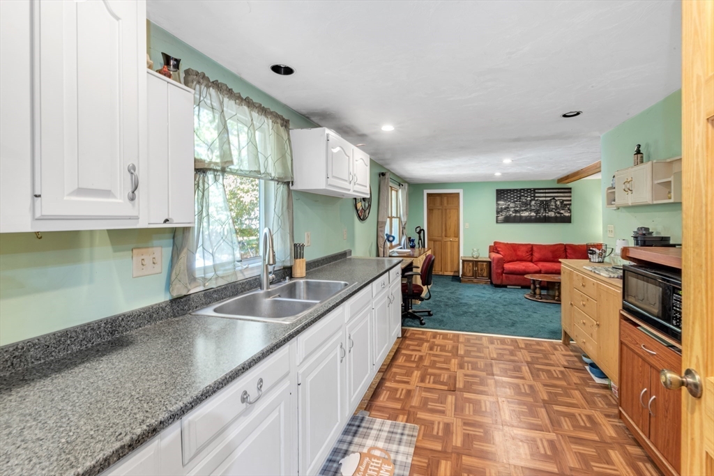 324 Central Avenue Dedham, MA 02026 - Photo 19 of 27 a large kitchen with stainless steel appliances granite countertop a lot of counter space and a sink